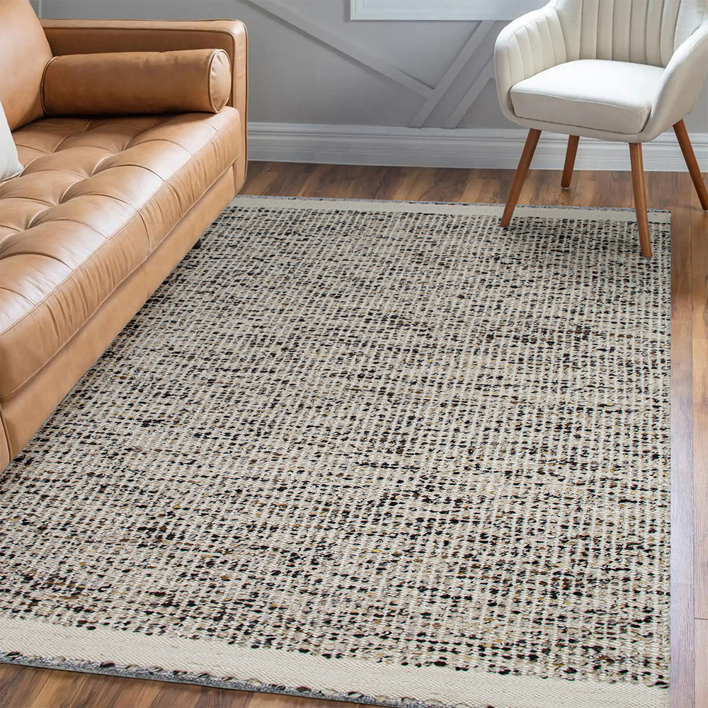 textured cream and bown speckeld rug with white border