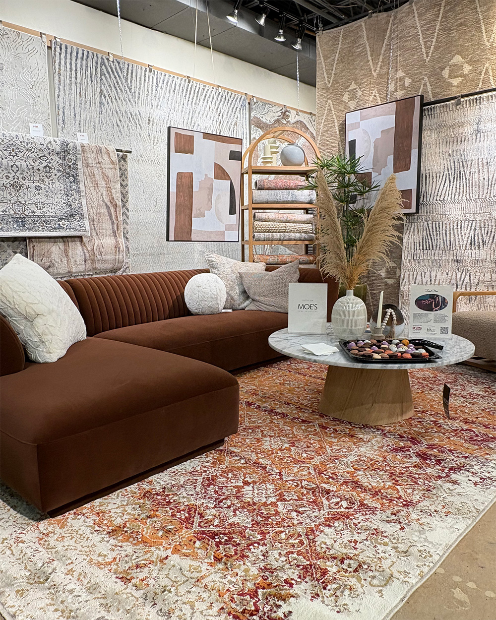 rugs handing on wall in showroom with desk